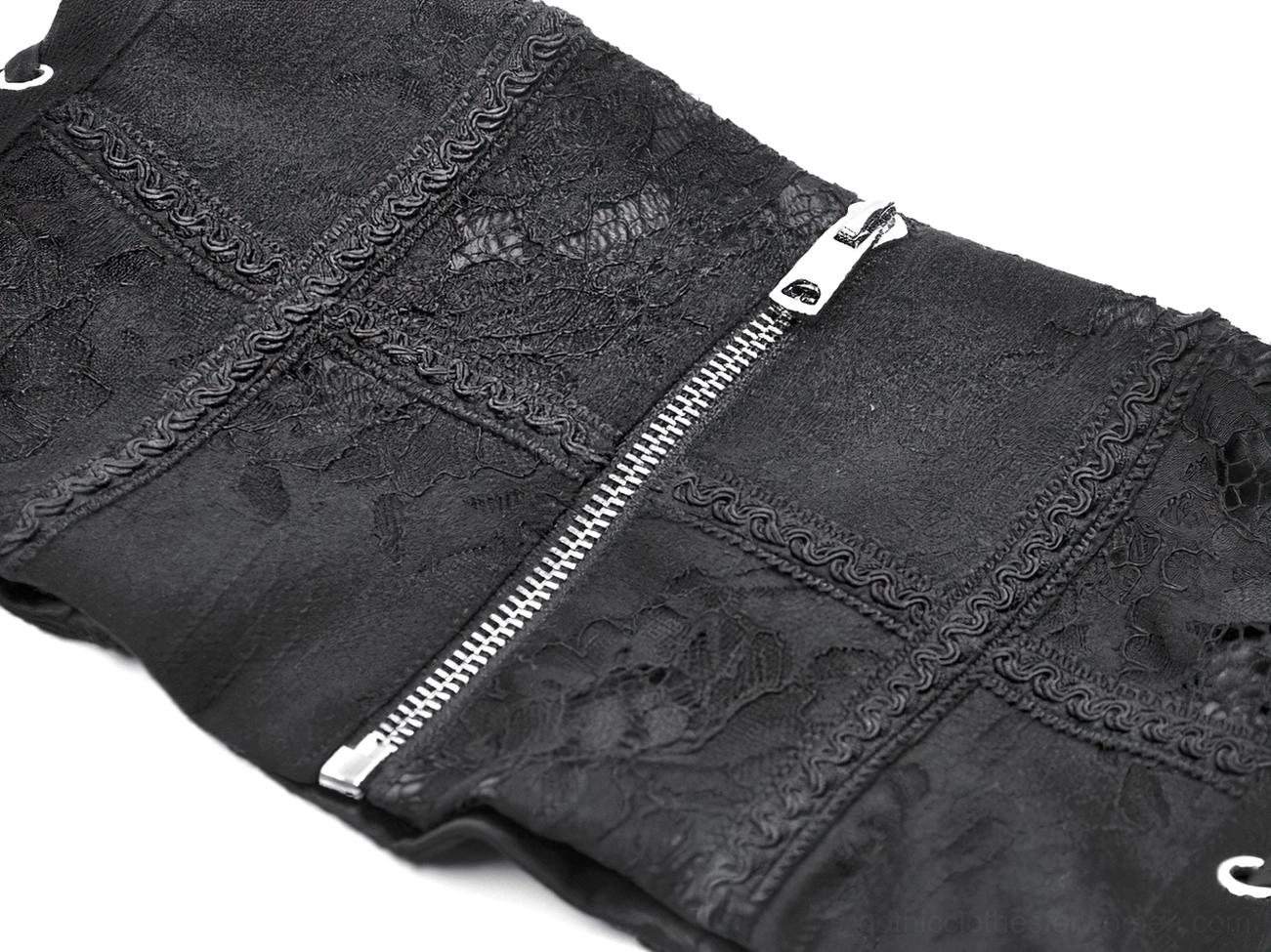 Macro close-up of black gothic corset showing embroidered floral lace and metal hardware