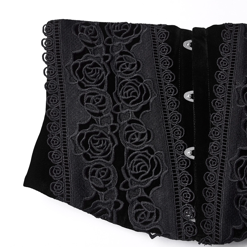 Close-up of black gothic corset front panel showing detailed rose lace appliqué, metal hook fasteners, and decorative scalloped trim
