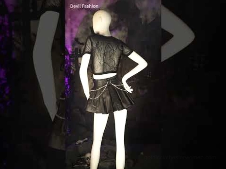 Black punk bustier crop top styled on mannequin with gothic aesthetic - dark background with pleather skirt pairing