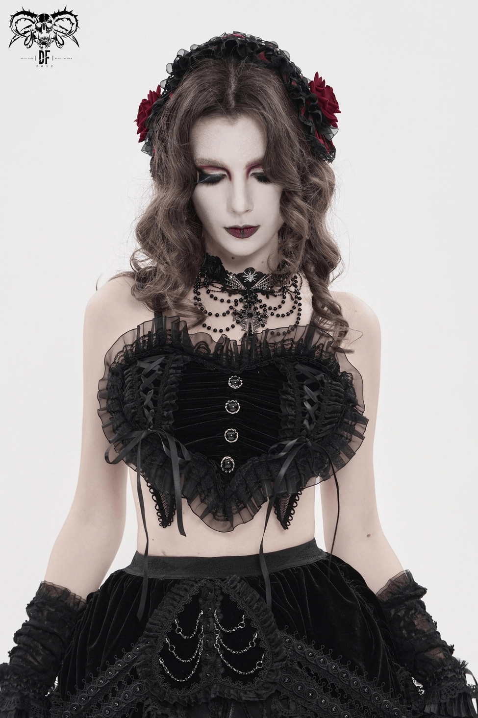 Black gothic crop top showing ruched front panel construction and elastic stretch fabric quality