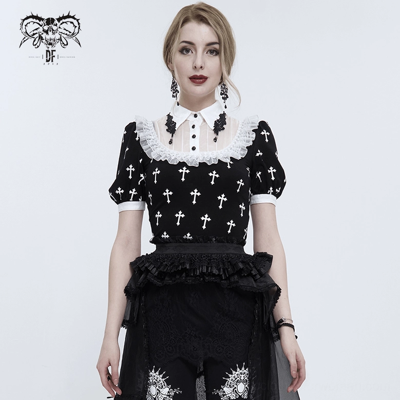 Full body front view female model wearing black gothic cross blouse paired with black ruffled tiered skirt