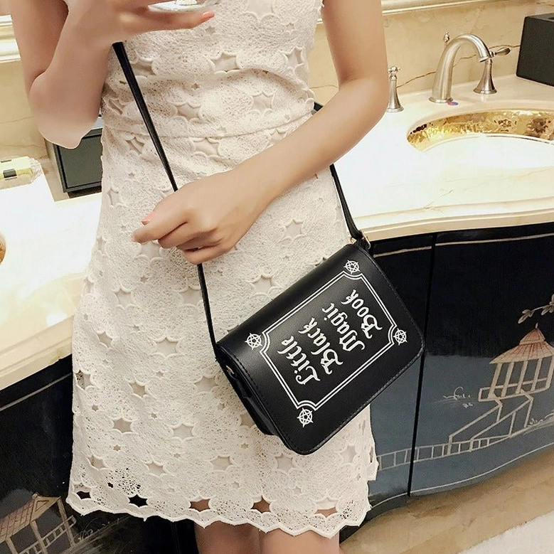Black gothic crossbody shoulder bag showing complete front design with letter printing and alternative fashion style