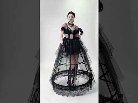 Black lace gothic dress detail close-ups showing cage hoop skirt structure and sheer tulle overlay