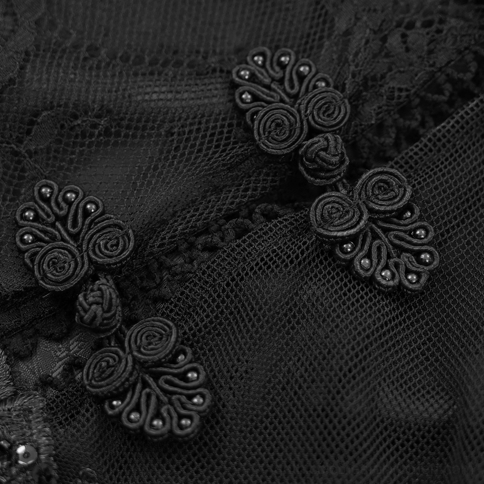 Close-up of black gothic dress mesh lace fabric and decorative beaded frog button fastening detail