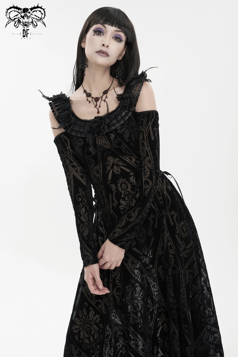 Full-length view of gothic midi dress on model demonstrating overall silhouette, damask pattern, and feather-trimmed design