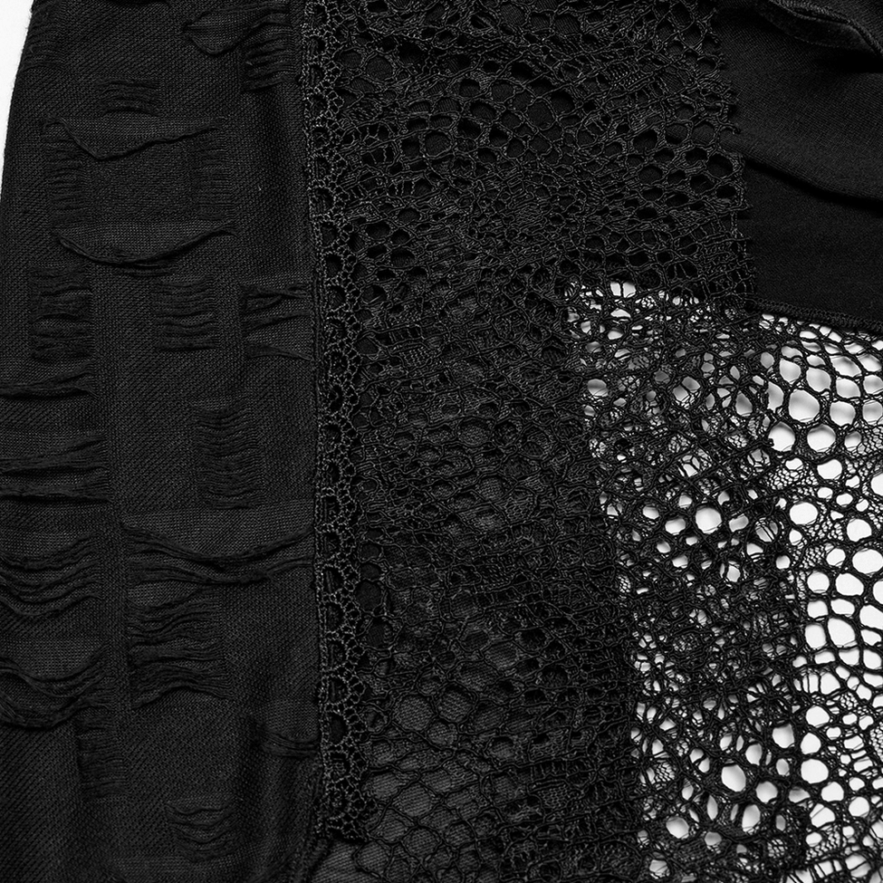 Close-up of black gothic lace dress layered fabric construction showing fishnet mesh and lace texture