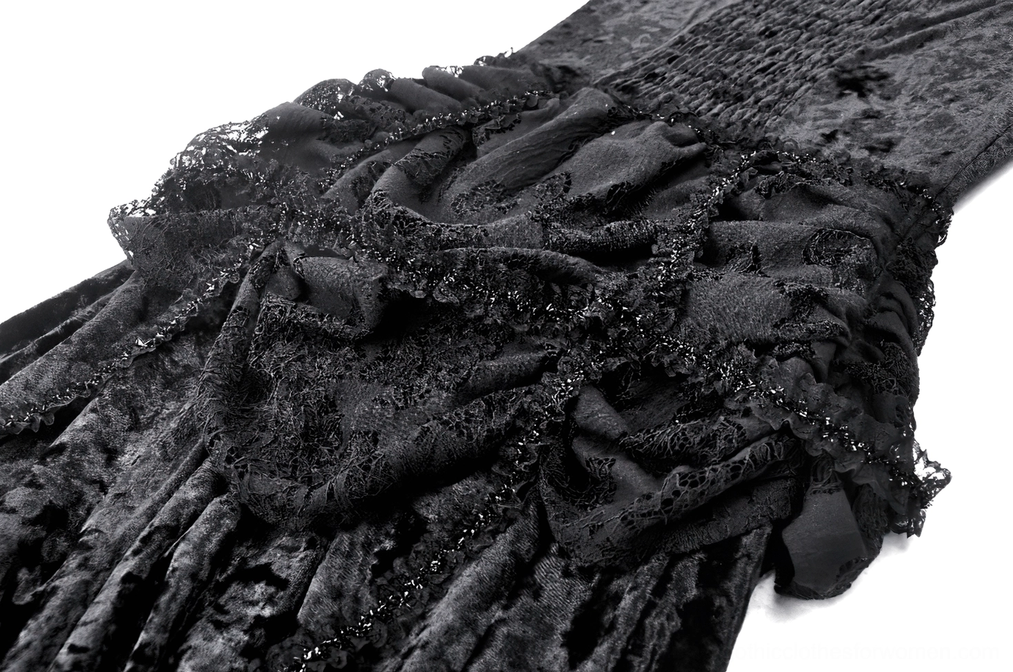 Close-up detail of black gothic dress neckline and shoulder, showing crushed velvet texture and lace trim edge
