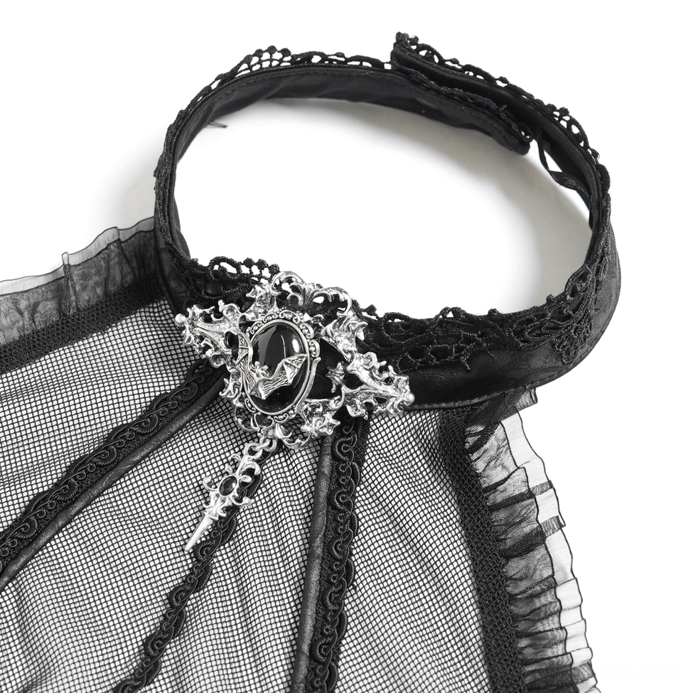 Close-up detail of black gothic dress neckline with lace trim, sheer mesh panel, and vintage gem brooch