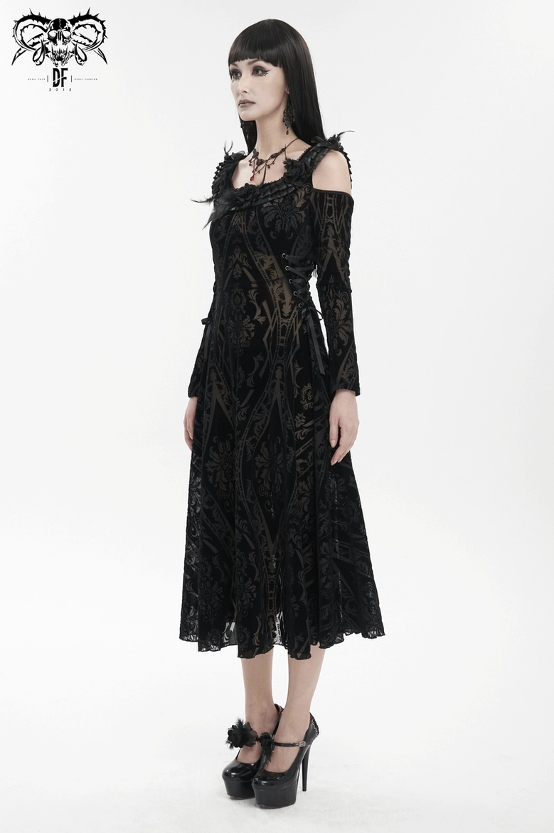 Model wearing black gothic off-shoulder dress in three-quarter view with damask print and accessory styling demonstration