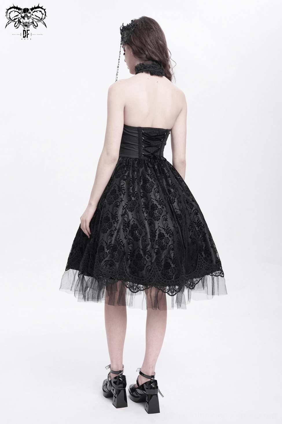 Black gothic halter dress close-up showing textured lace overlay and corset bodice construction