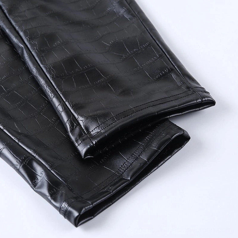 Detailed product shot of black high-waist gothic faux leather pencil pants, highlighting crocodile grain embossing and material finish