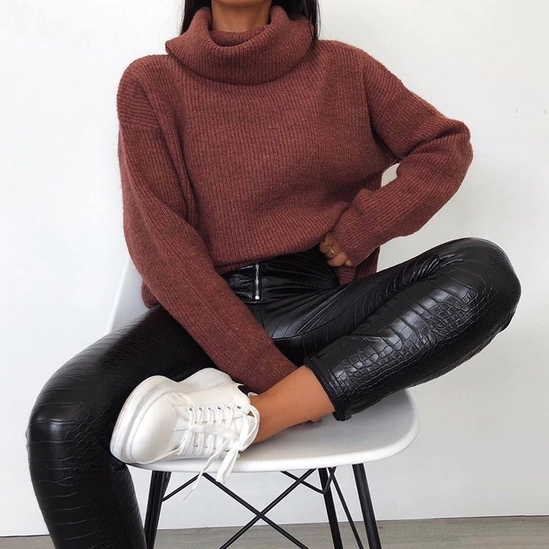 Front-facing studio image of black high-waist gothic faux leather pencil pants on model, showing sleek silhouette and premium finish