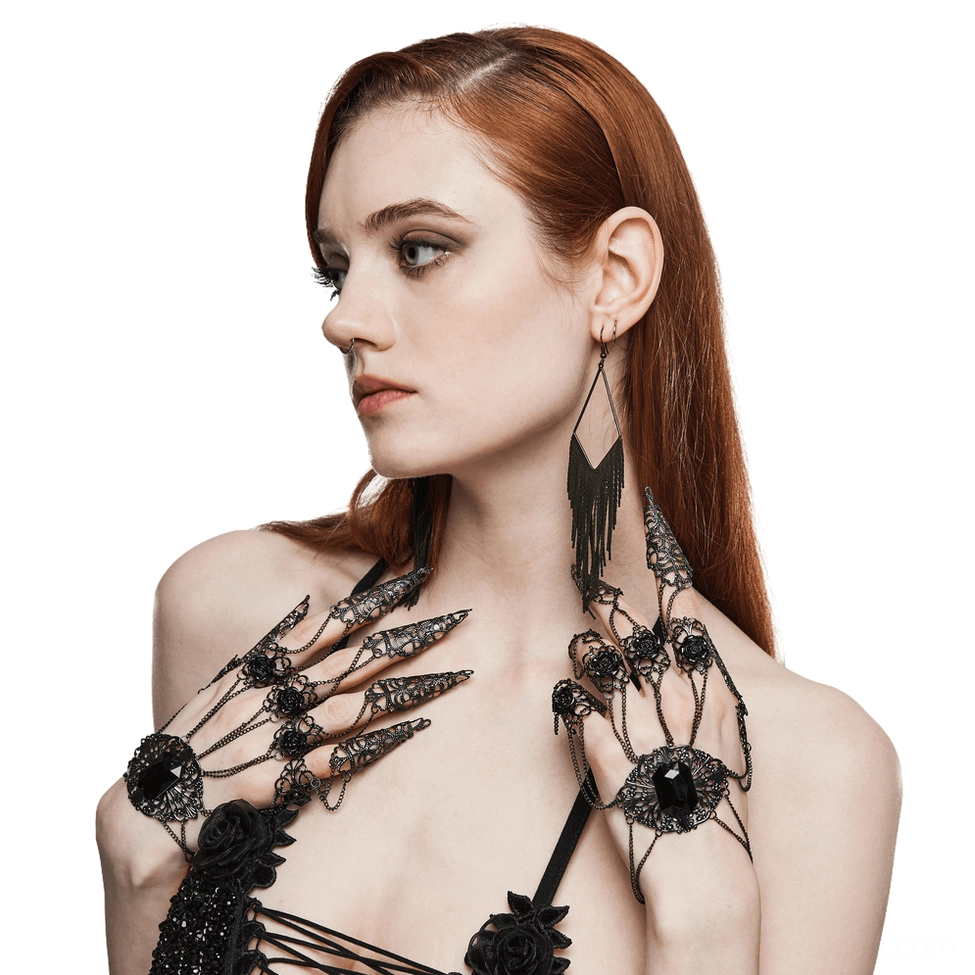 Gothic finger hand chain with rose buckle and claw nail tassel worn on model's left hand, side profile view with black filigree metalwork and faceted gemstone center