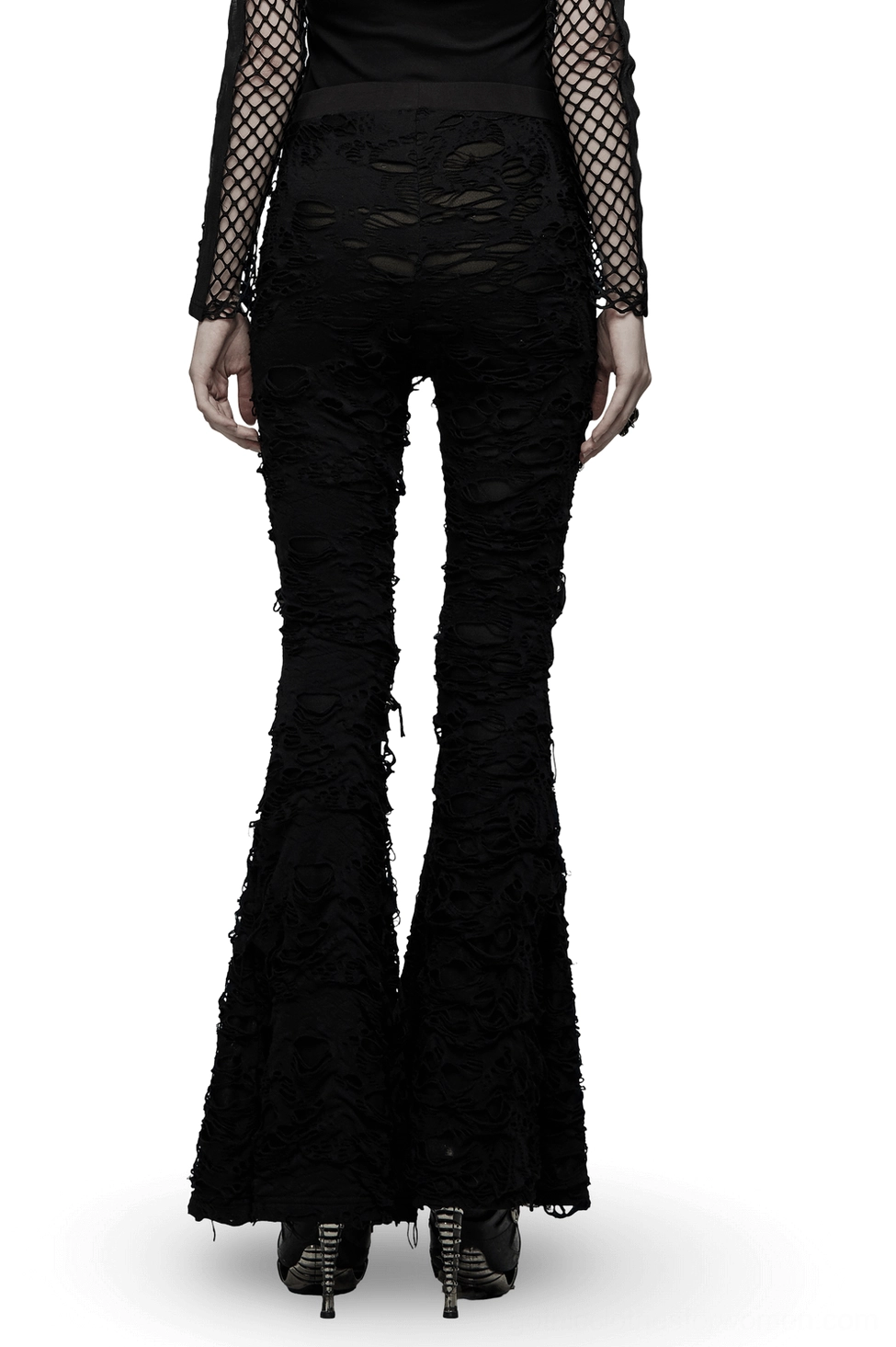Black gothic flare pants with distressed frayed edges and bell bottom silhouette, rear full view on model