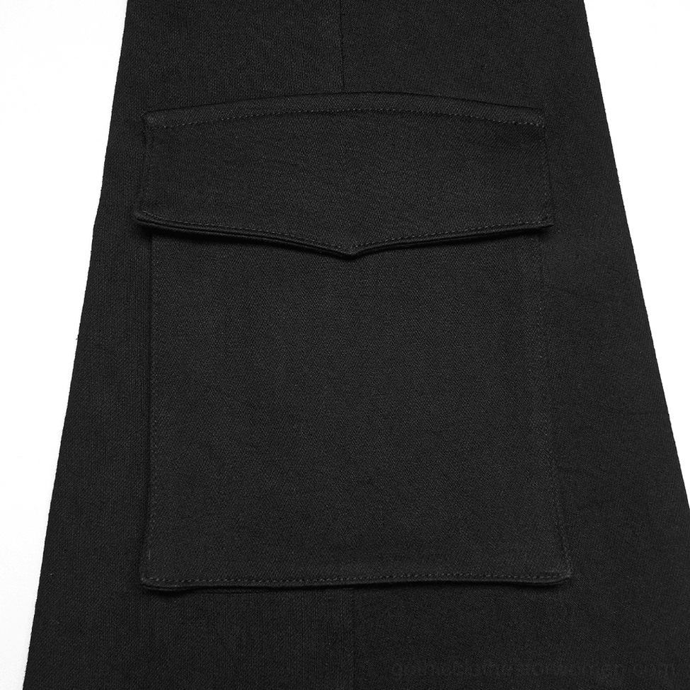 Close-up flat lay of black flared leg warmer component showing multi-layer cargo pocket construction and fabric layering