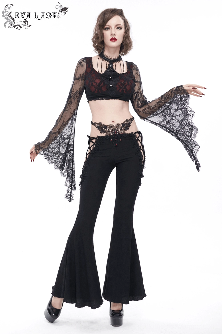 Profile view of black lace-up gothic flared trousers showing the dramatic hem and overall silhouette