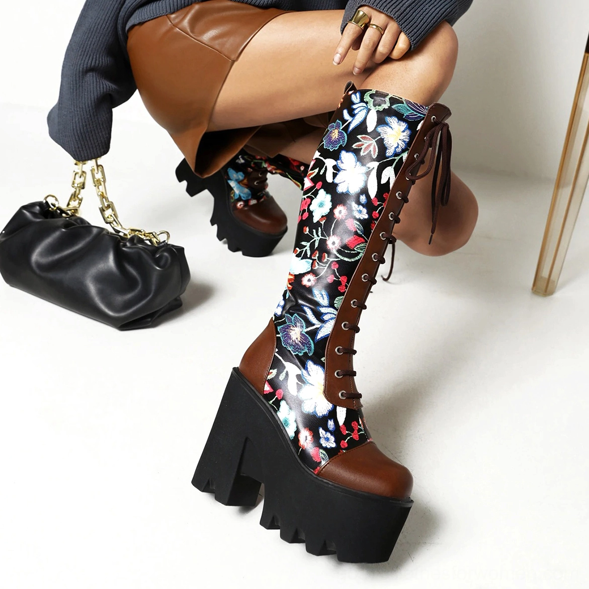 Full product showcase of black gothic floral platform knee-high boots emphasizing punk-goth design aesthetic