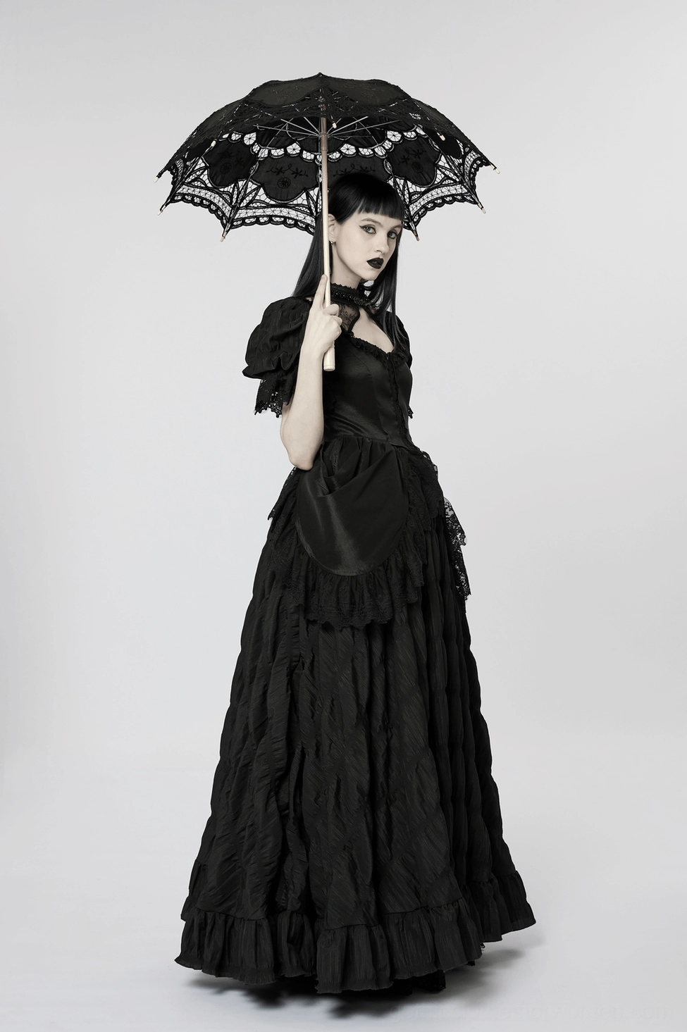 Black Victorian gothic gown detail showing front square neckline cutout, pearl-embellished lace collar, and clasp closure