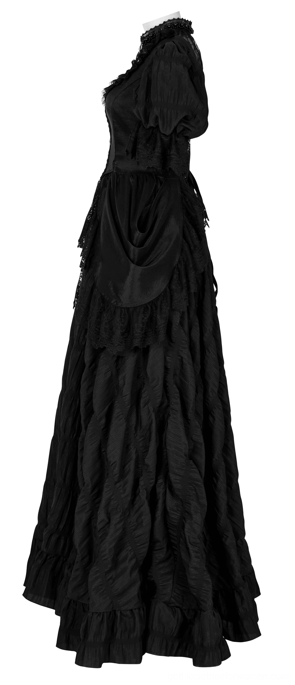 Black gothic gown side profile showing draped waist and layered ruffled floor-length skirt construction on mannequin