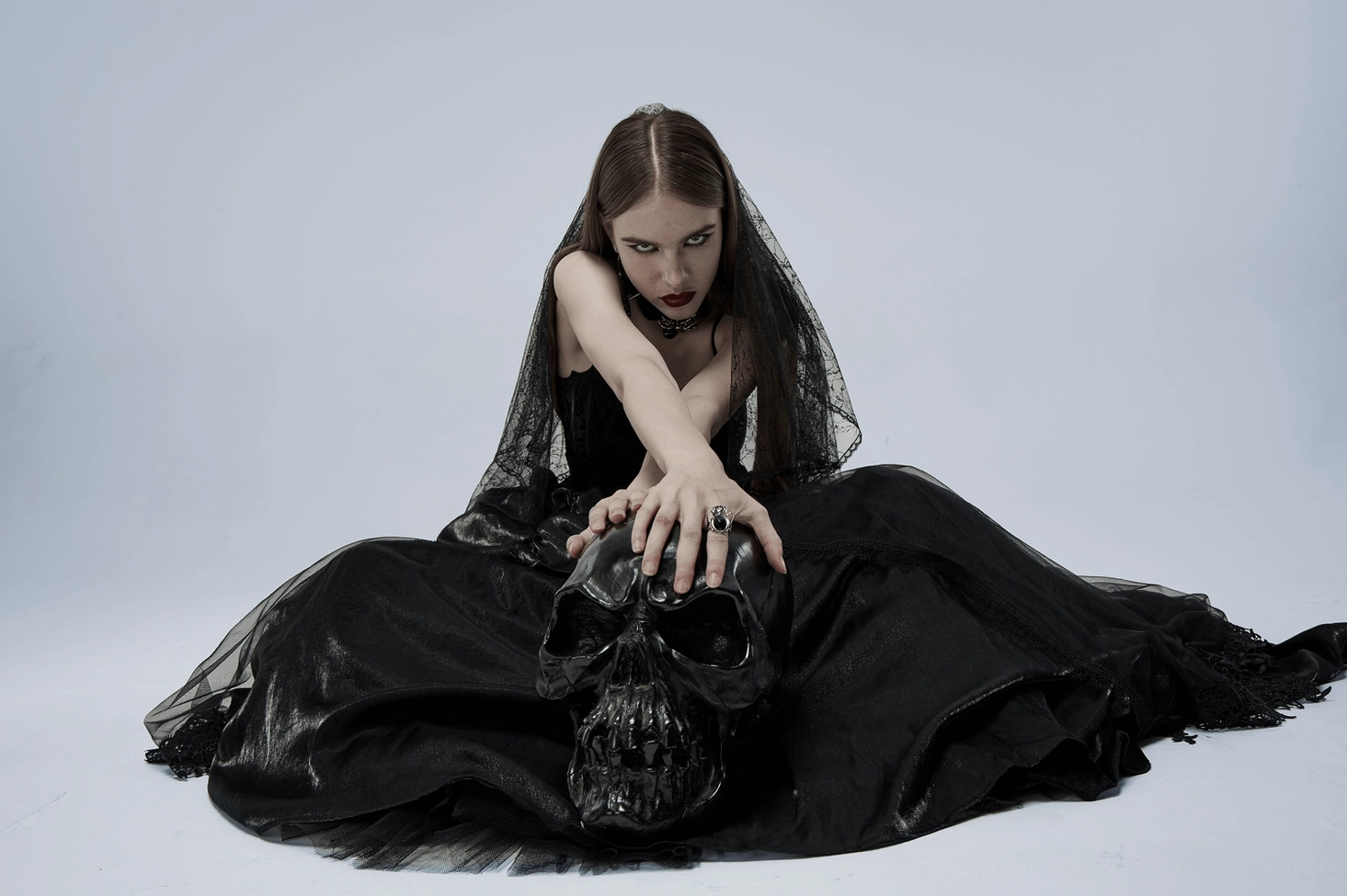 Model wearing black gothic gown demonstrating fit and drape of tulle skirt layers