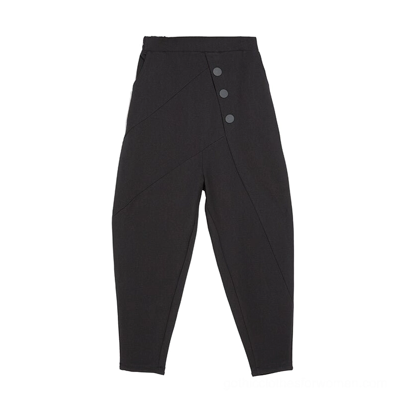 Black gothic harem pants flat lay display showing asymmetrical stitching, decorative buttons, and tapered leg opening