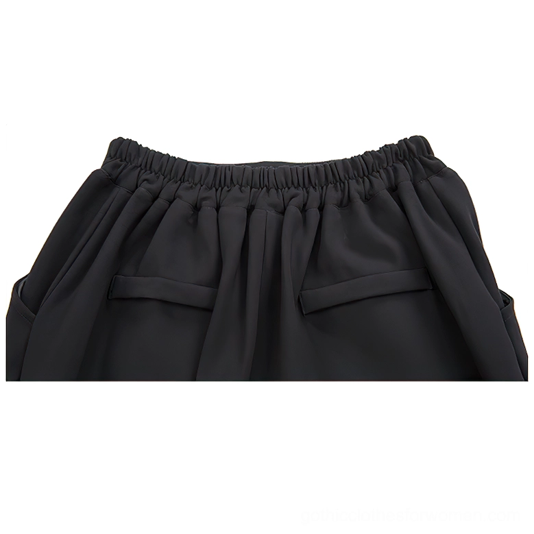 Close-up detail of black gothic harem pants rear waistband showing elastic construction and back pocket stitching