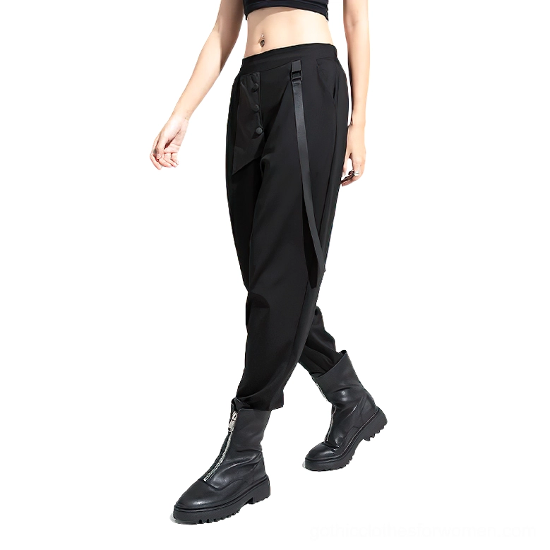 Black gothic harem trousers with side ribbon trim and asymmetric pockets worn by model in front three-quarter view with combat boots and cropped top