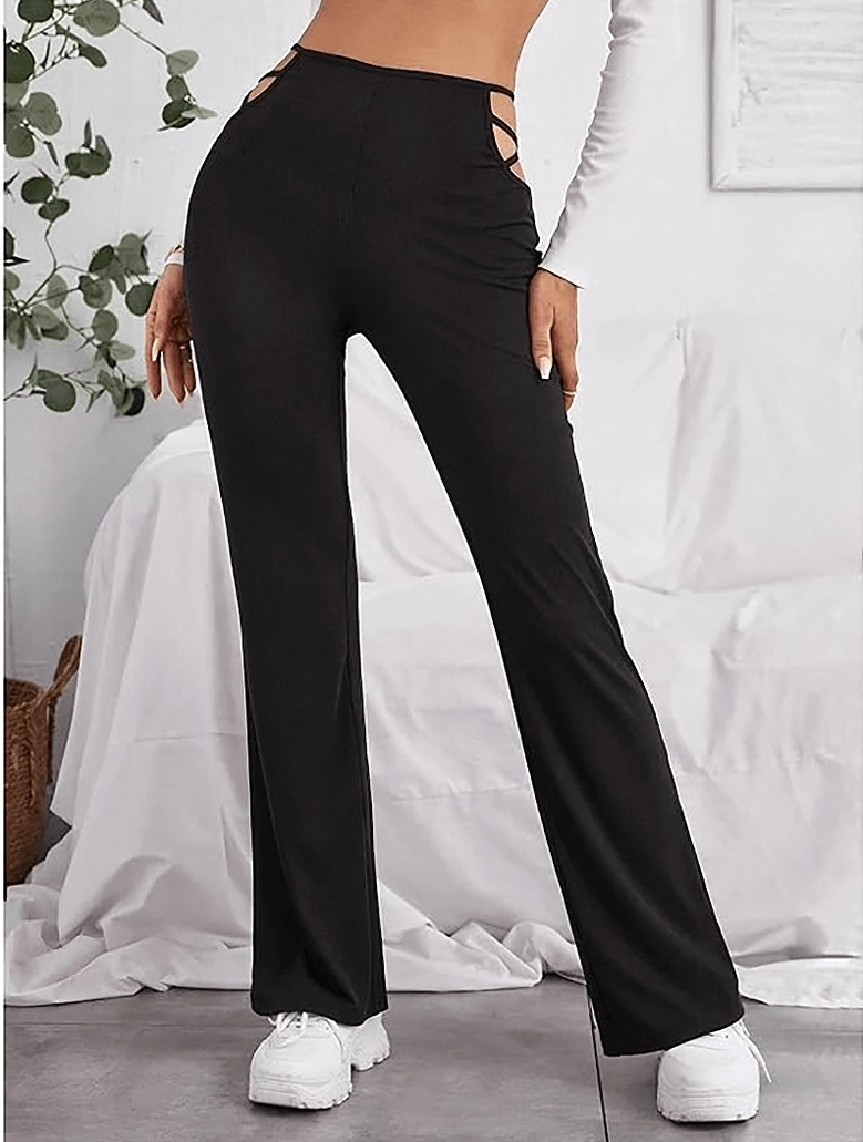 Black gothic high-waist hollow-out flared pants side view with white sneakers, alternative style