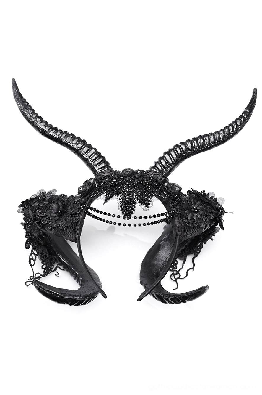 Black horned gothic headpiece with curved ram horns and floral lace decoration on display, front view without forehead chain