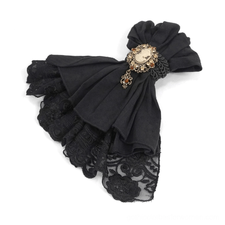 Overhead flat lay of black gothic lace jabot showing ruffle, floral lace pattern, and ornate cameo brooch