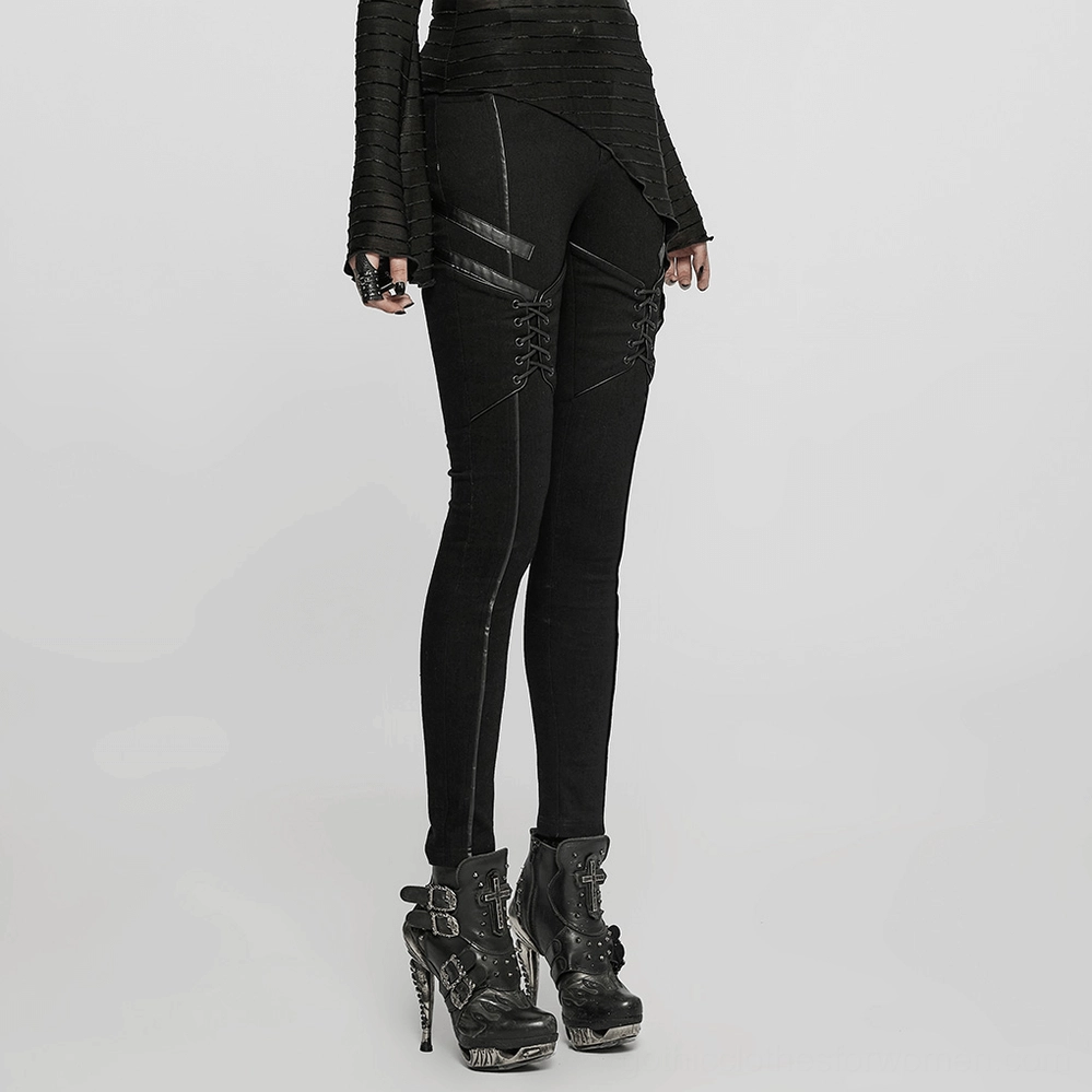 Front lace-up detail of black gothic skinny jeans, close-up of corded lacing system, leather accents, and reinforced stitching on women's punk denim