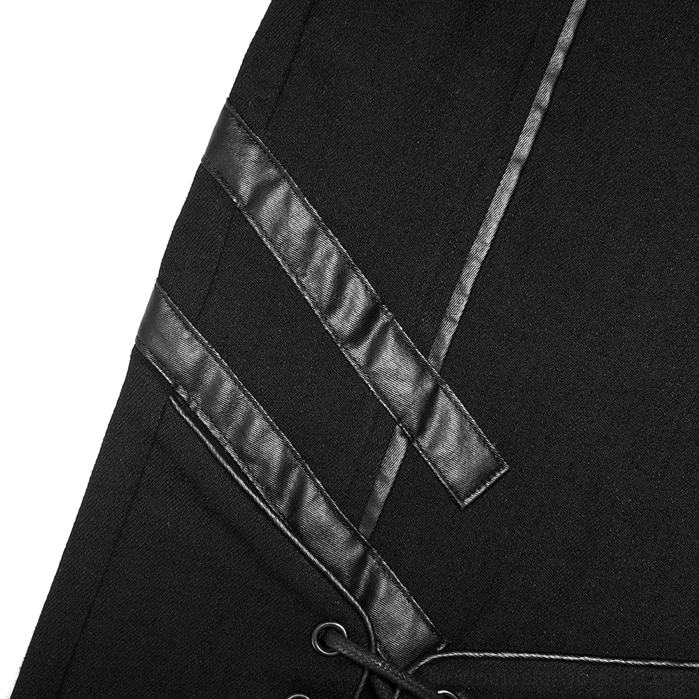 Close-up of black gothic lace-up skinny jeans thigh trim showing leather strips, metal eyelets, and intricate lacing system detail