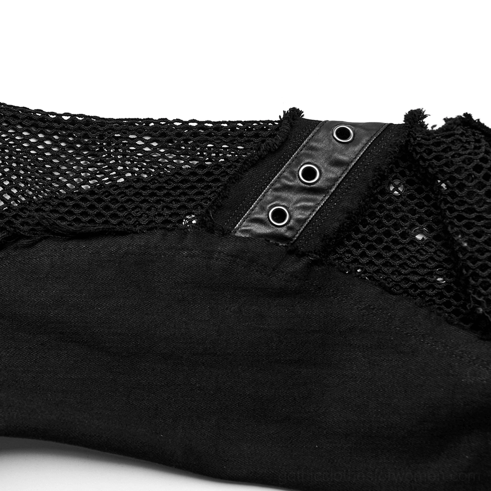 Close-up of crossed leather straps with metal eyelets on black gothic flare jeans