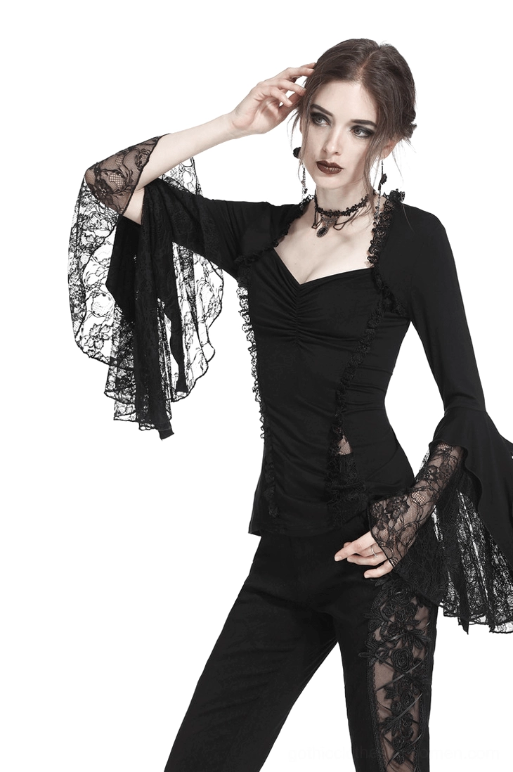Full body front view of model wearing black gothic lace bell sleeve top with sweetheart neckline