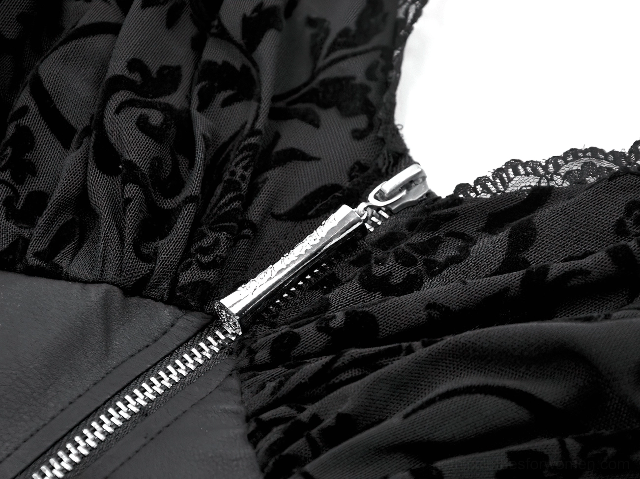 Close up front view of black gothic dress silver metal zipper and floral lace fabric detail