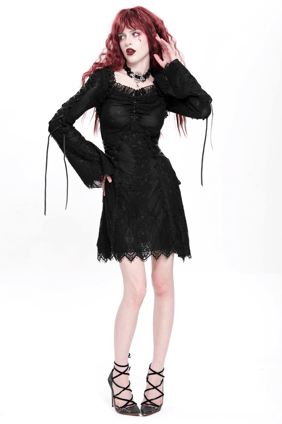 Gothic black lace mini dress full-length flat lay with lace-up side accents and scalloped finish