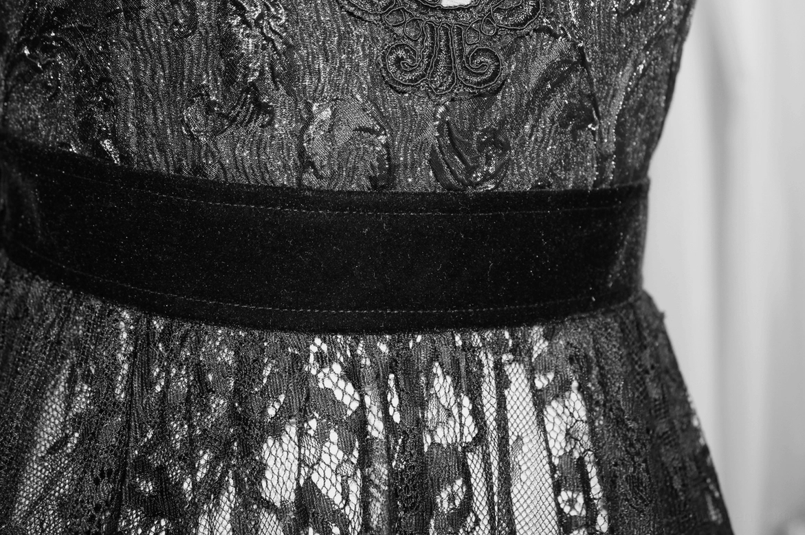 Black gothic lace dress full ensemble view showing overall silhouette, asymmetric hem, and design composition