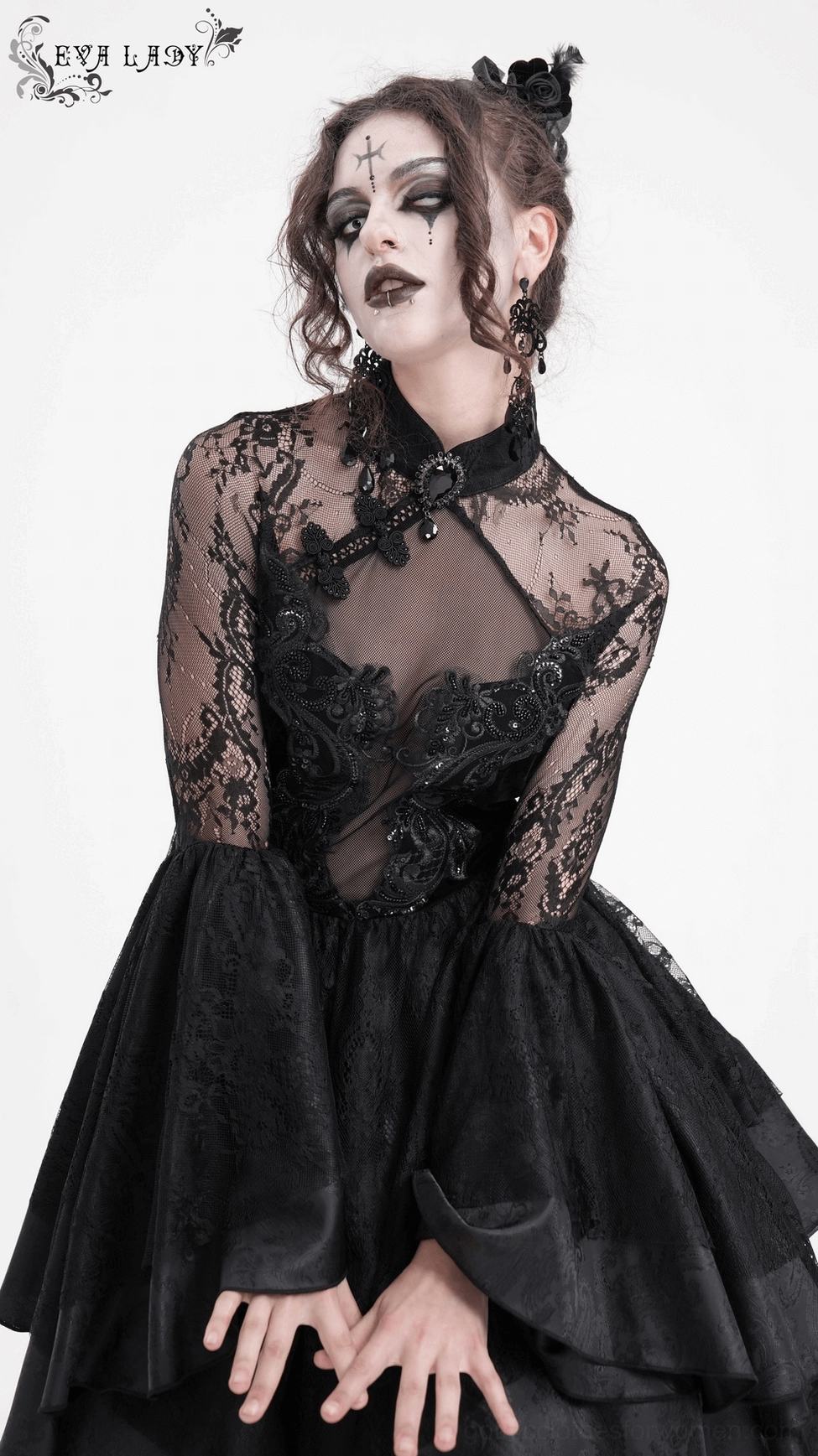 Black gothic lace dress detail showing ornamental gemstone collar accent and refined neckline construction