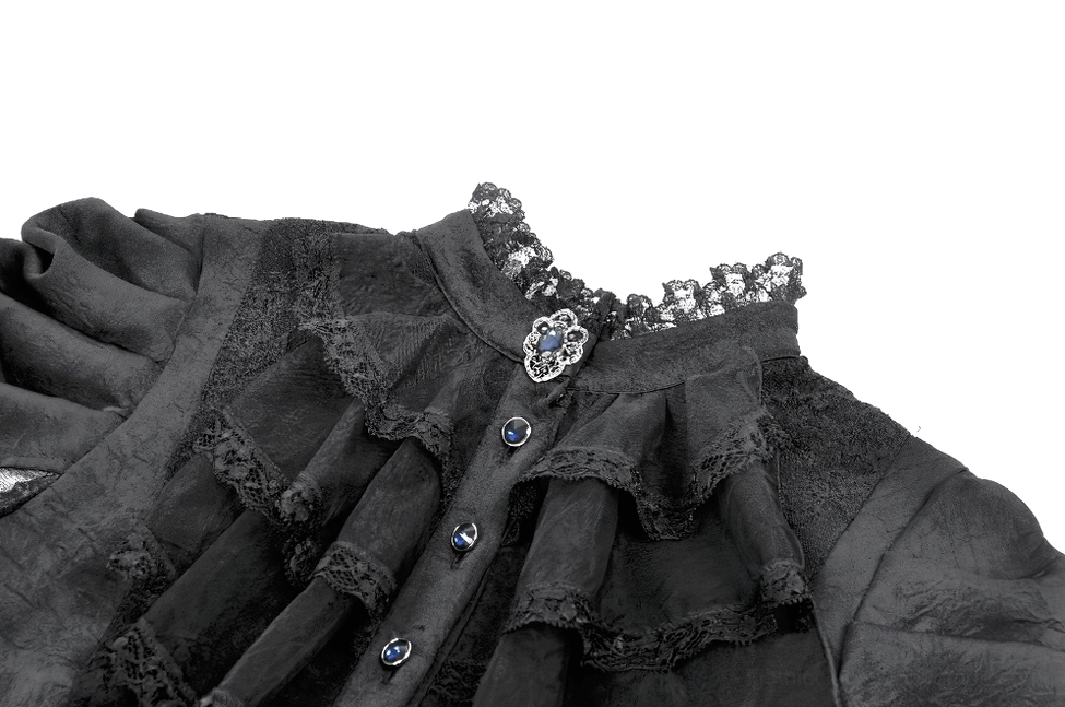 Close-up detail of black gothic dress front neckline showing ruffled lace collar with beaded and gem button embellishments