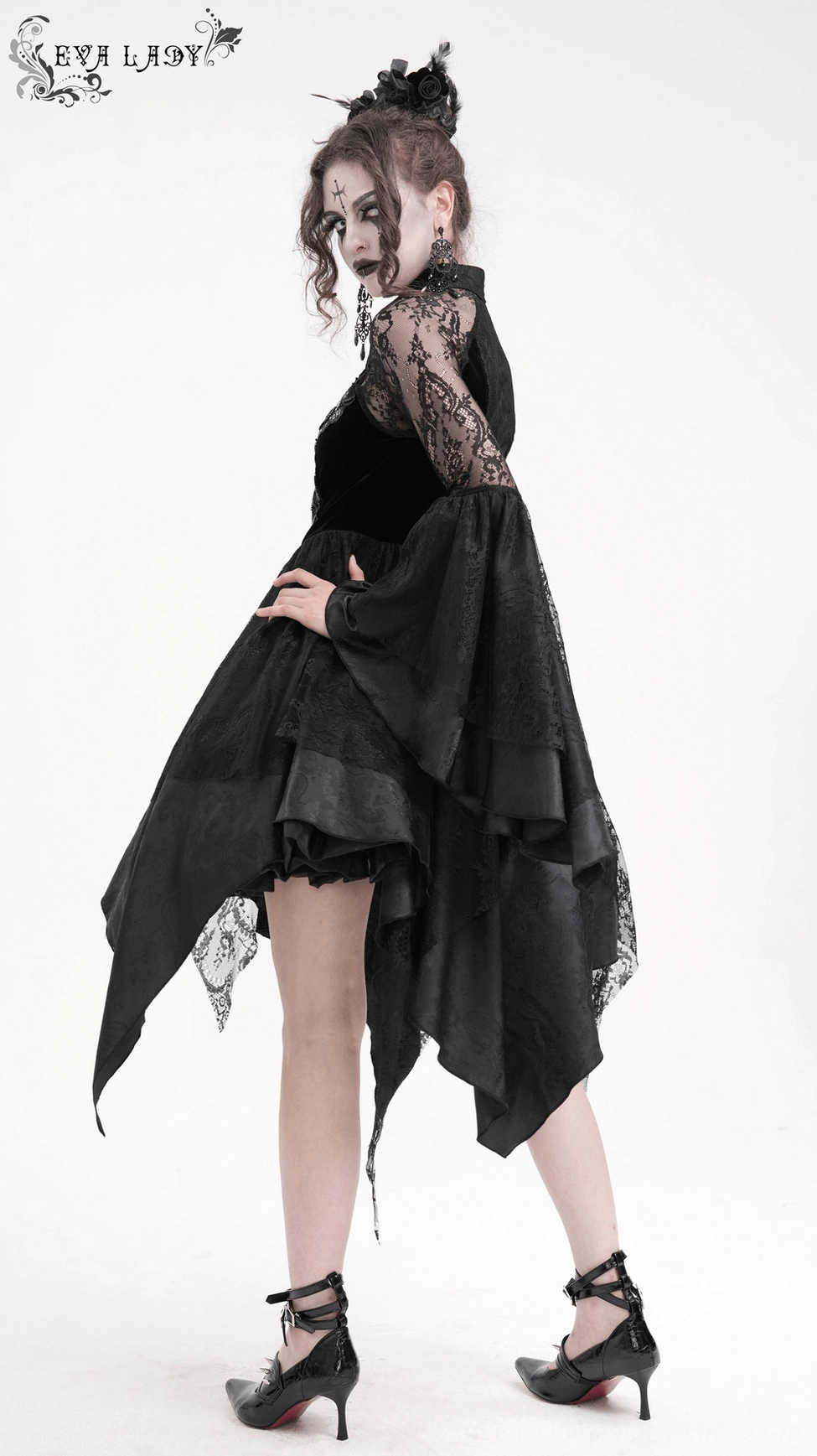 Black gothic lace dress three-quarter view showing asymmetrical hemline and sheer lace sleeve construction