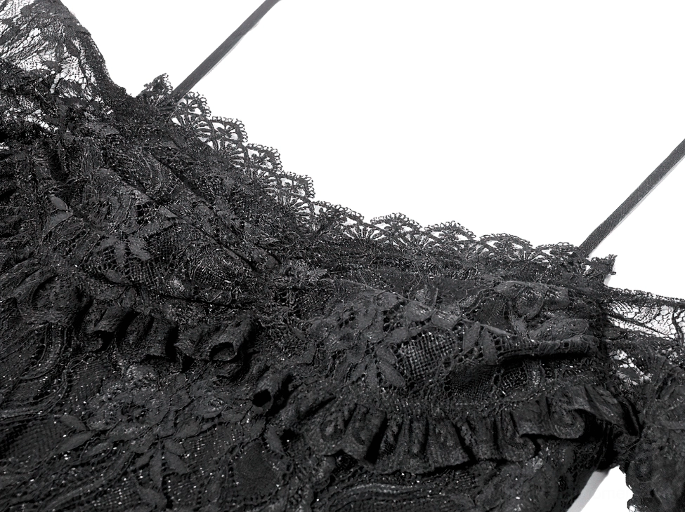 Macro close-up of black floral lace fabric on gothic party dress, highlighting intricate lace pattern and ruffled edge texture