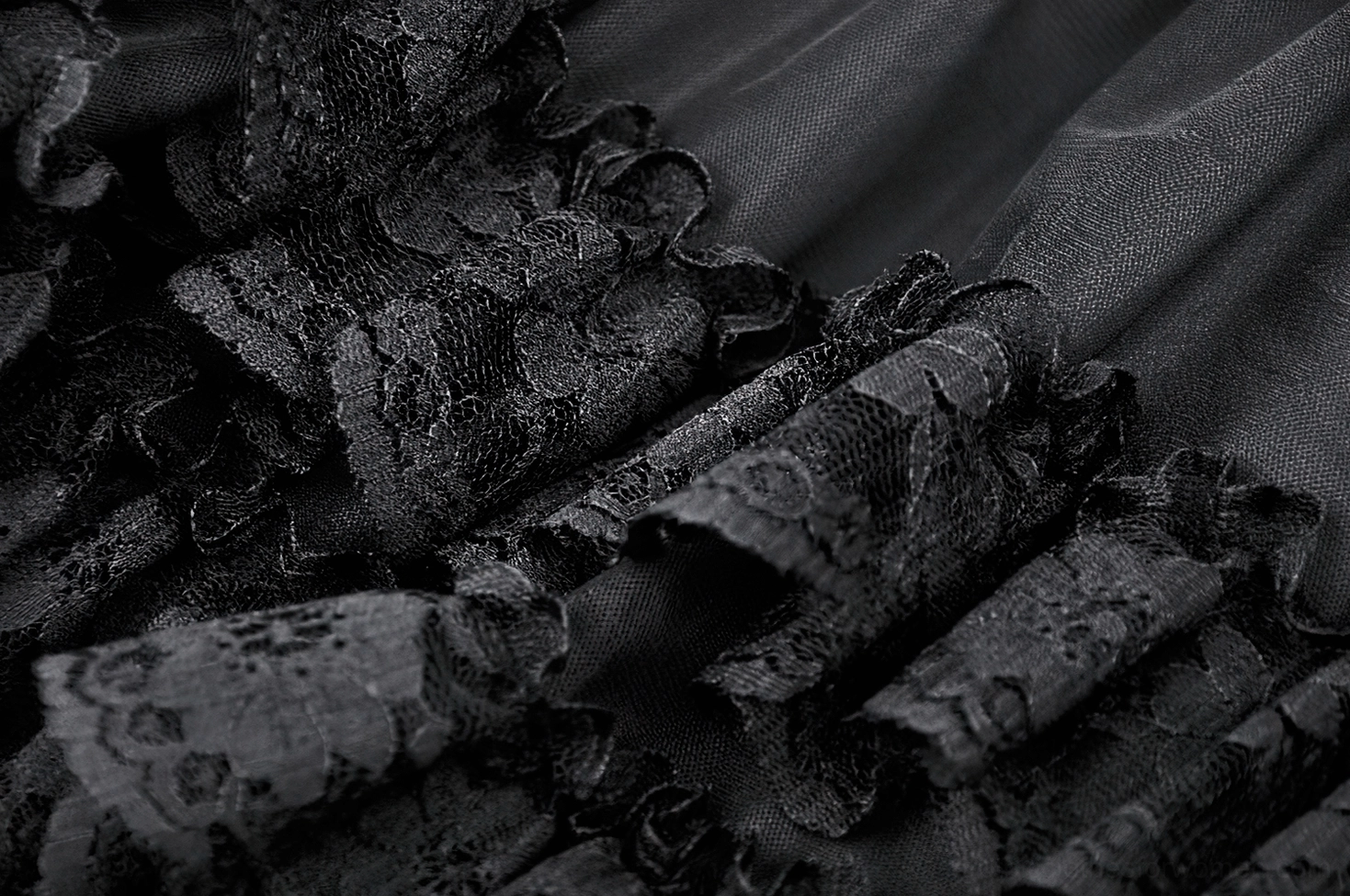 Alternative styling of black gothic lace mini skirt with corset waistband and cross accent - lifestyle image