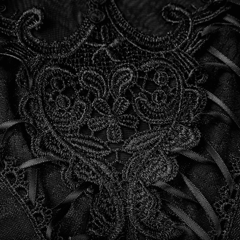 Macro close-up of intricate floral scroll lace embroidery and ribbon lace-up details on black gothic tank top