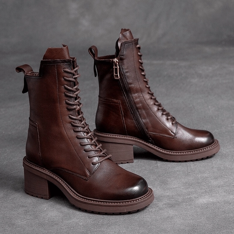 Complete pair of black gothic lace-up leather ankle boots with motorcycle-inspired design