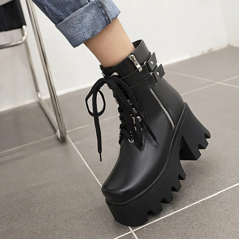 Black lace-up gothic platform boots with side zipper, three-quarter view demonstrating the architectural round toe and smooth leather upper
