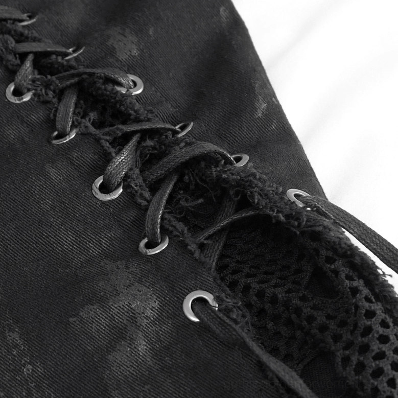 Side lace-up detail of black gothic punk trousers showing metal eyelets, fabric laces, and fishnet panel texture