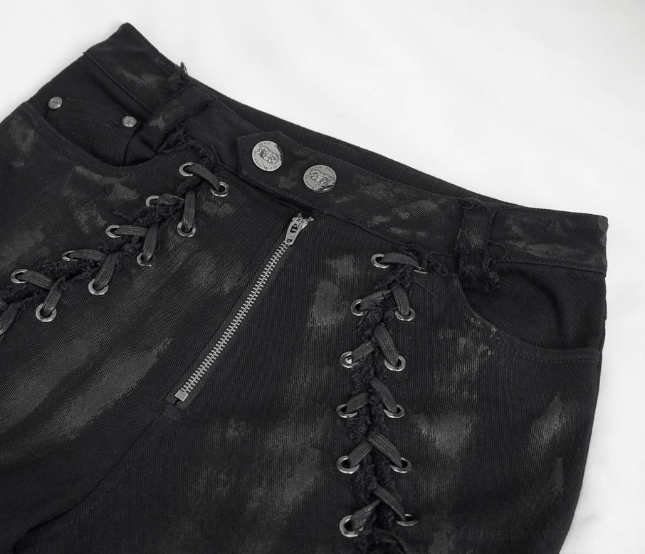 Front waist detail of black gothic punk trousers showing dual lace-up sides with metal eyelets and button closure