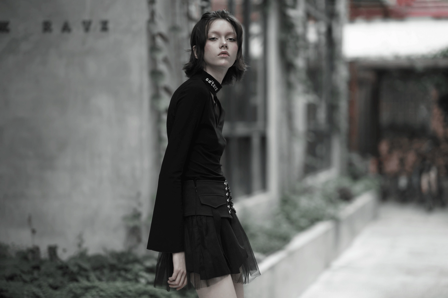 Black gothic lace-up mini skirt alternative fashion styling with accessories and dark aesthetic presentation