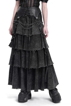 Black layered gothic maxi skirt with chain straps worn by model showing full front silhouette with tiered ruffles and distressed edges