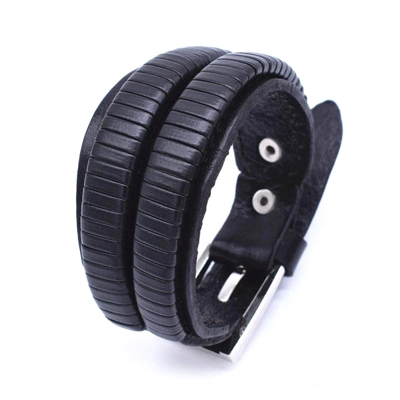 Black wide leather gothic cuff bracelet back oblique view revealing ribbed surface texture and buckle mechanism